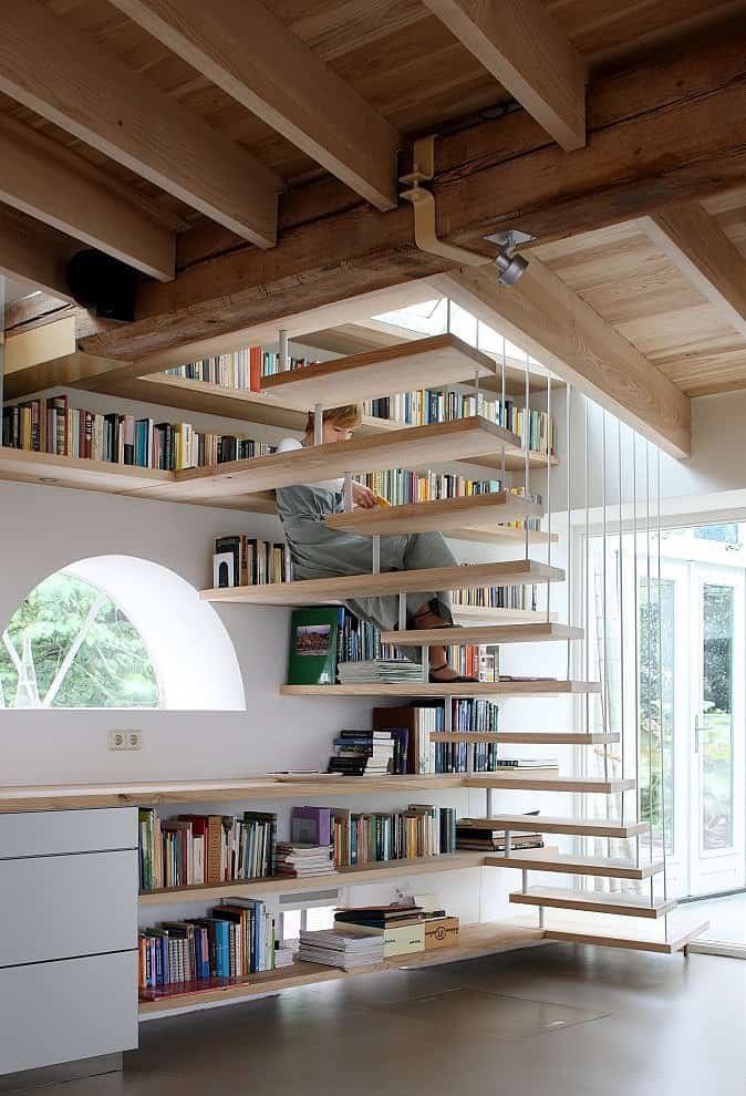 Libros organizados por colores en la escalera biblioteca